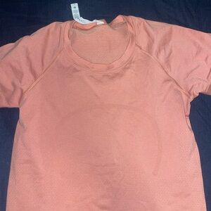 Peach color lululemon workout top